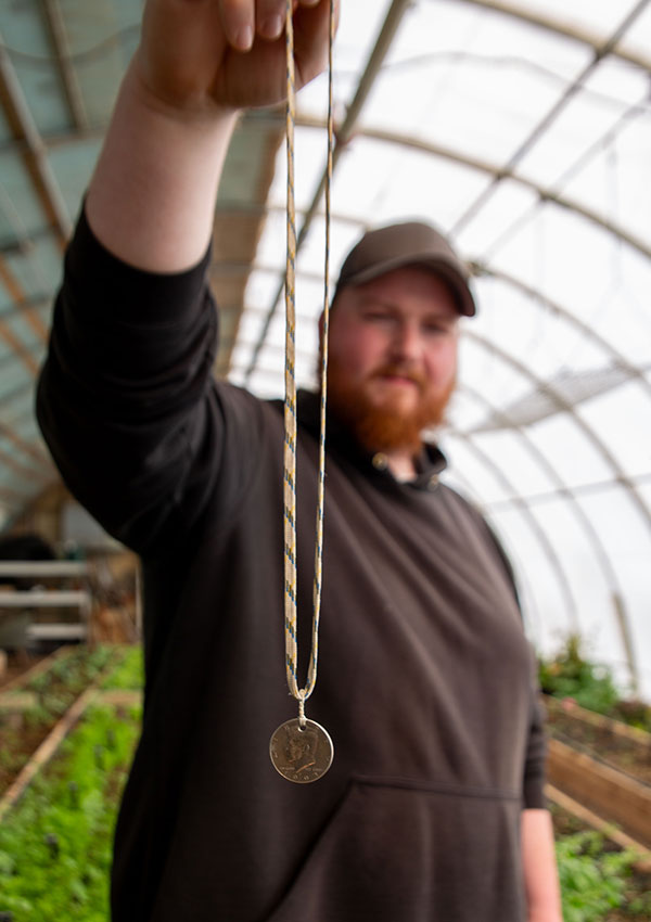 Dan holding his coin necklace